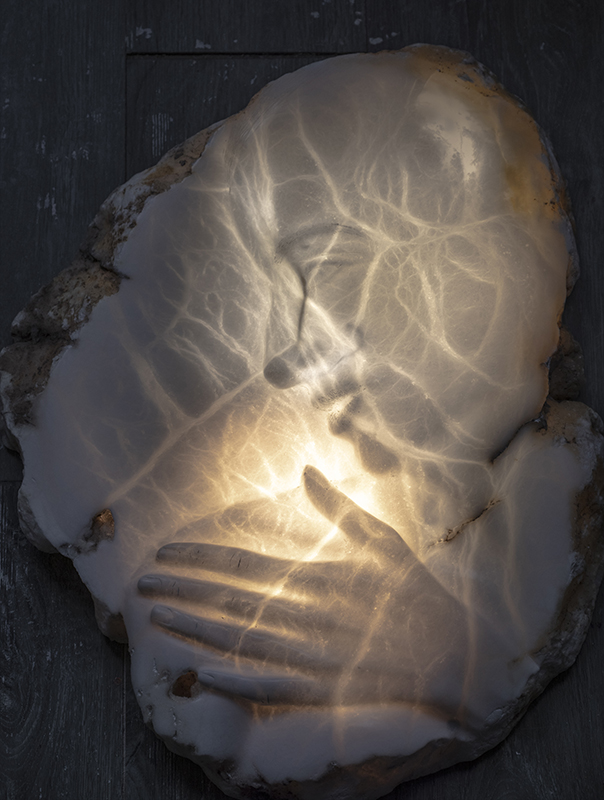 IZA, Isabelle Ardevol, woman contemporary artist, sculptress, art, Louise is a contemporary portrait carved in alabaster and backlit.  It's part of the In Chaotic lands serie, inspired y the societal changes due to global warming